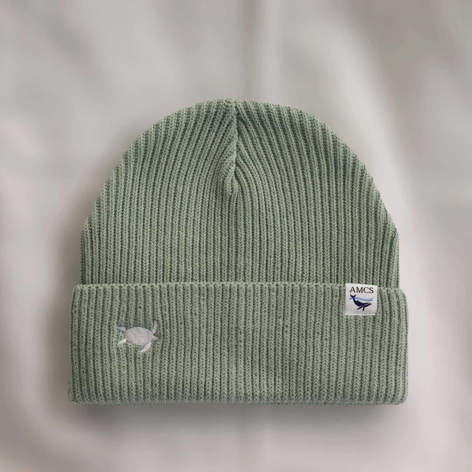 Ocean Icons organic cotton, sage beanie embroidered with a turtle in white thread.