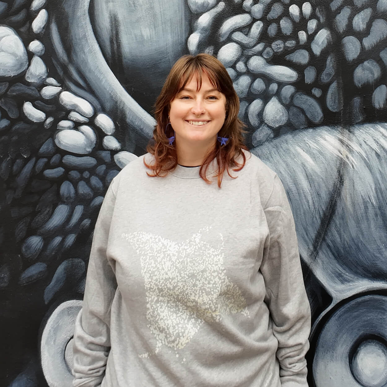 Fragile Oceans heathered grey sweatshirt with manta ray screen print worn by our AMCS team.