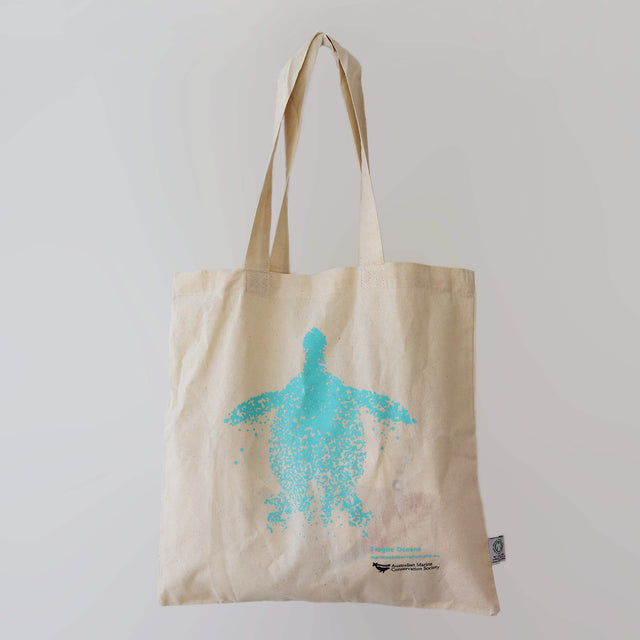 The Fragile Oceans organic cotton, natural-coloured tote bag with artwork of a turtle by Collider, printed in teal.