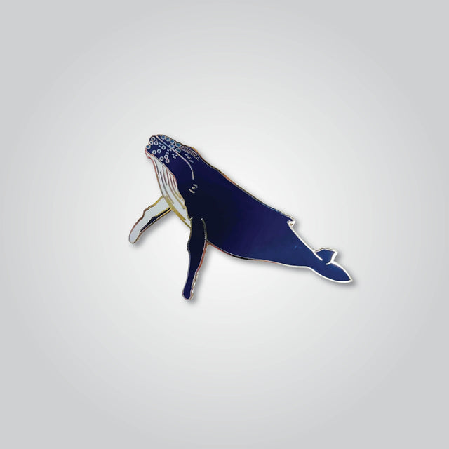 Lapel pin of a humpback whale by Red Parka.