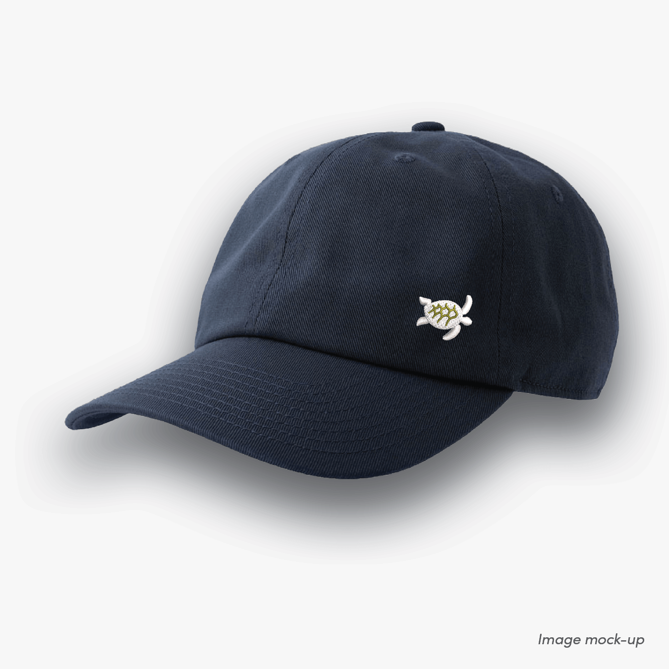 Navy-coloured Ocean Icons Dad cap with turtle embroidery on the side.