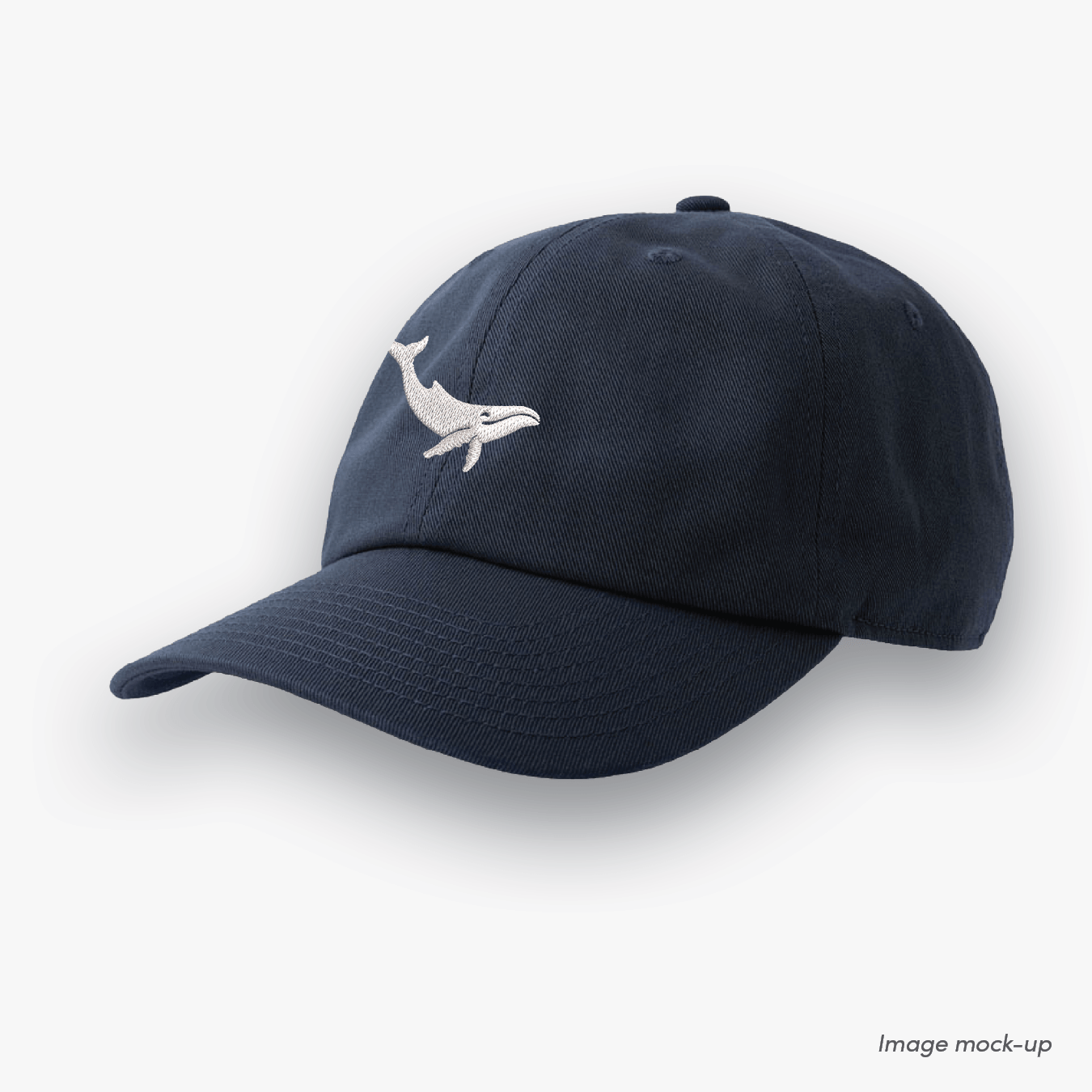 Navy-coloured Ocean Icons Dad cap with humpback whale embroidery centred.