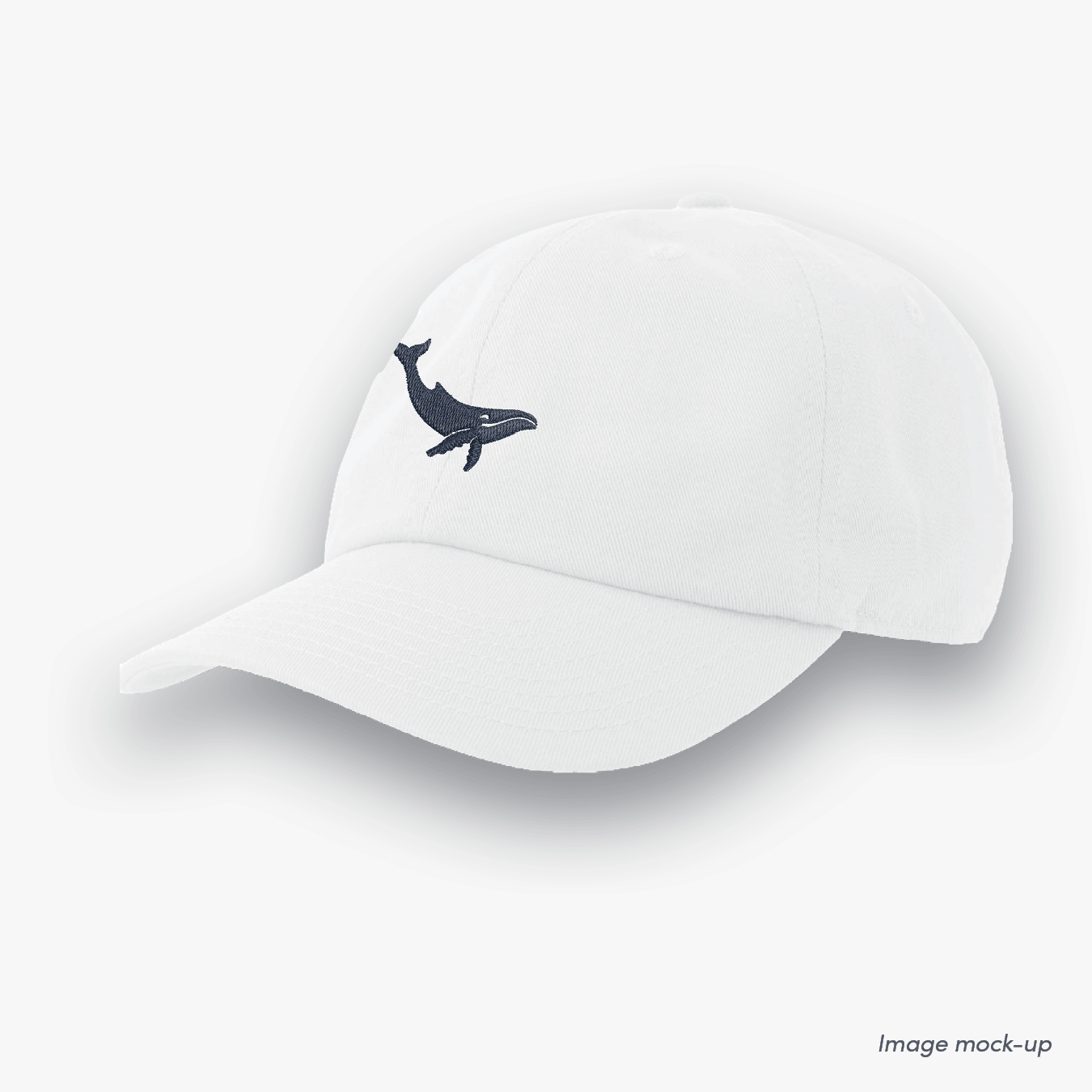 White-coloured Ocean Icons Dad cap with humpback whale embroidery.