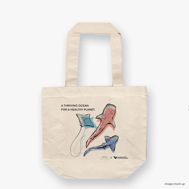 A natural canvas tote bag featuring screen-printed artwork of whale sharks and a manta ray by Guy Shoval, together with the AMCS vision statement: "A thriving ocean for a healthy planet".
