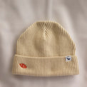 Ocean Icons organic cotton, beige beanie embroidered with a clownfish in orange thread.
