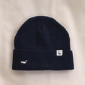 Ocean Icons organic cotton, navy beanie embroidered with a humpback whale in white thread.