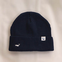 Ocean Icons organic cotton, navy beanie embroidered with a humpback whale in white thread.