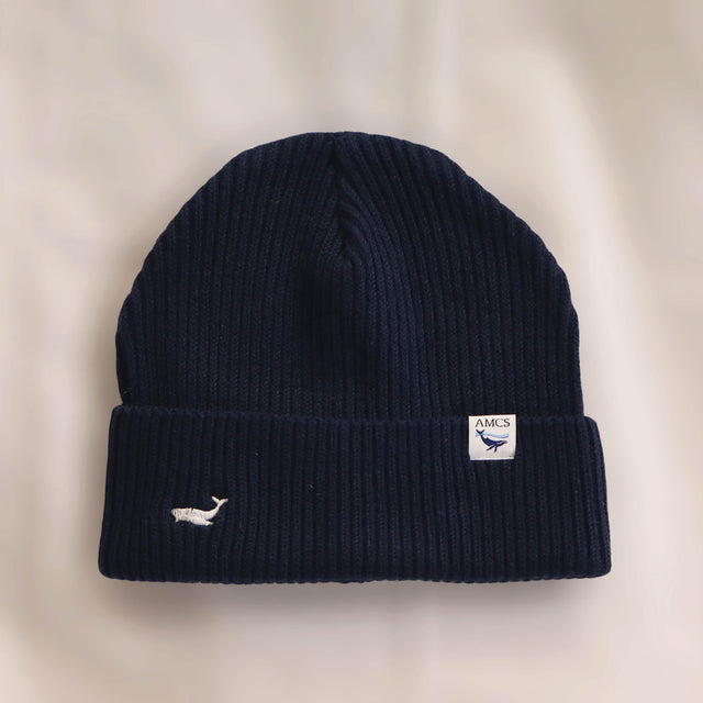 Ocean Icons organic cotton, navy beanie embroidered with a humpback whale in white thread.