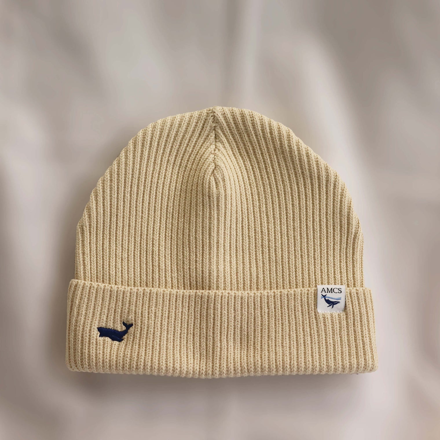 Ocean Icons organic cotton, beige beanie embroidered with a whale in navy thread.