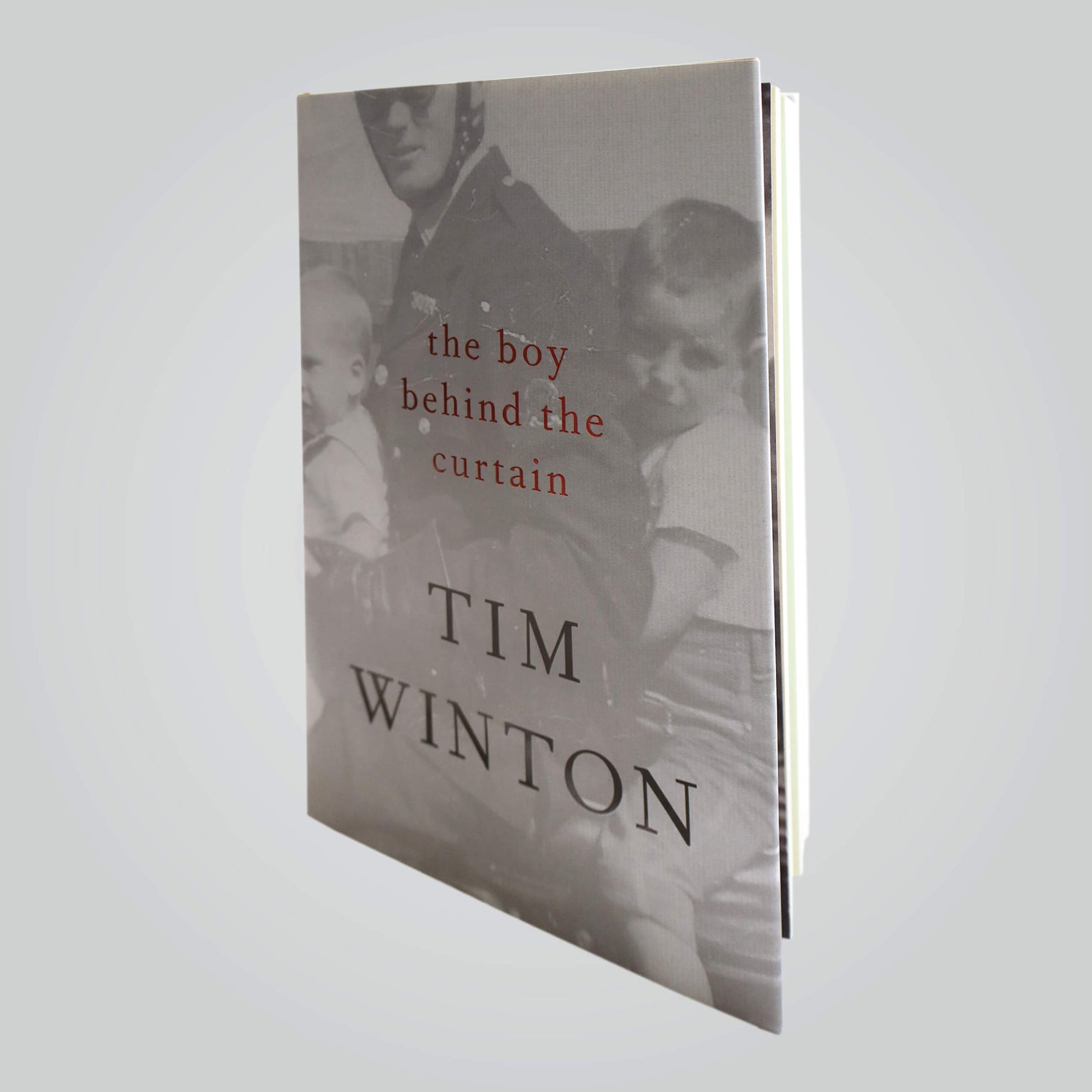 'The Boy Behind The Curtain' book cover (front) by multi award-winning Australian author and AMCS Patron, Tim Winton, featuring an image of a father with two children on a motorcycle.