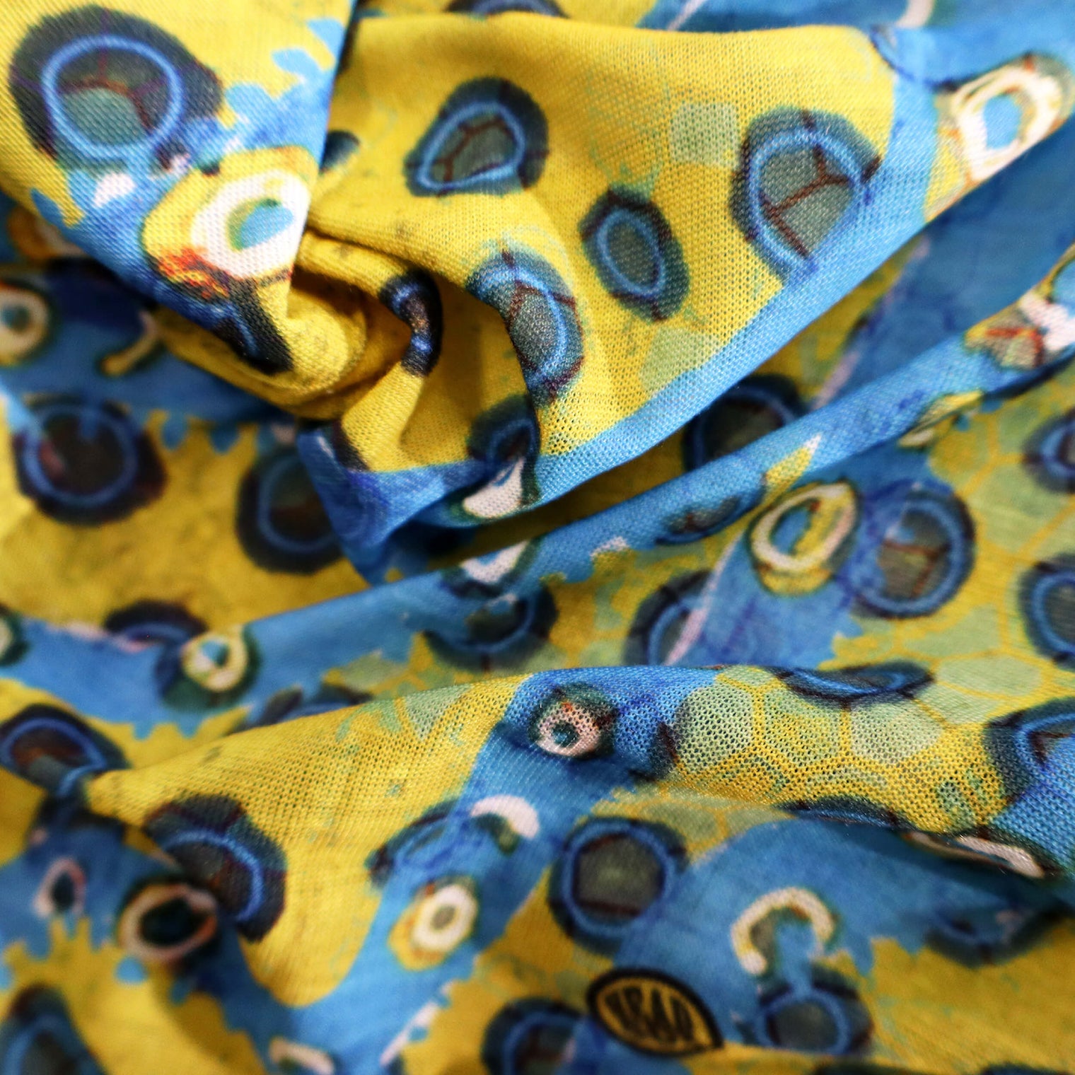 Close-up of the 'Ocean Life' buff fabric by Headsox in the multicoloured ‘Blue Ring Octopus’ design.