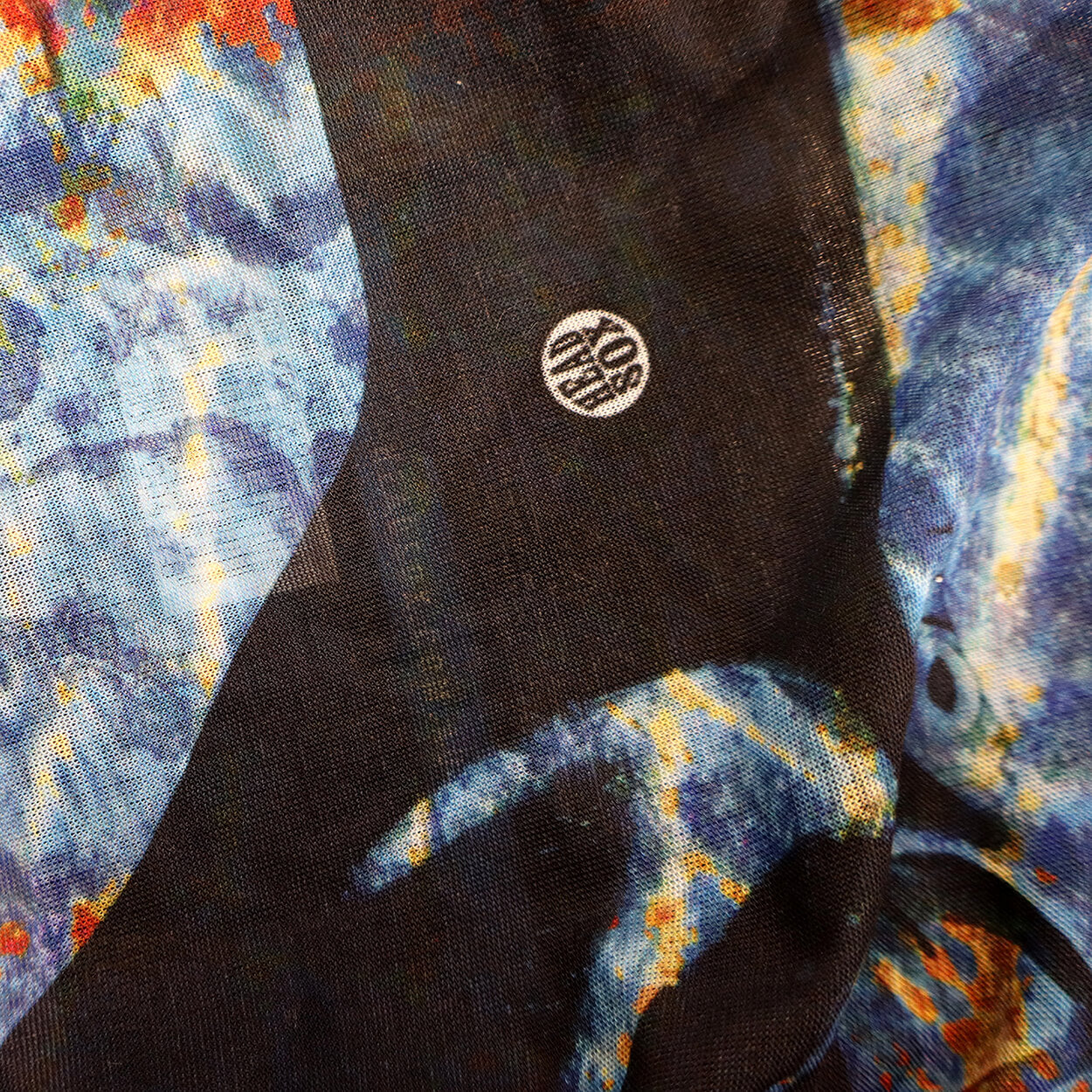 Close-up of the 'Ocean Life' buff fabric by Headsox in the multicoloured 'Manta Magic’ design.