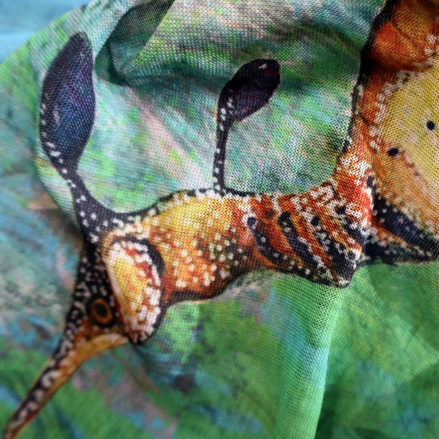 Close-up of the 'Ocean Life' buff fabric by Headsox in the multicoloured 'Sea Dragon’ design.