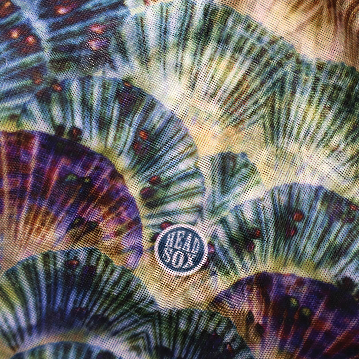 Close-up of the 'Ocean Life' buff fabric by Headsox in the multicoloured 'Sea Shells’ design.