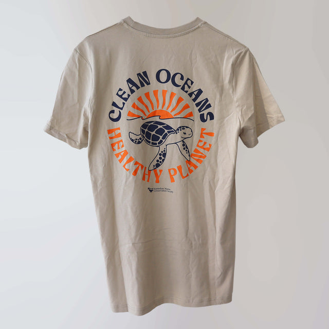 Sand-coloured 'Fight Plastic' organic cotton t-shirt (back) with navy and orange print artwork of a turtle and sun setting over the ocean horizon, with the campaign slogan “clean oceans—healthy planet”.