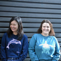 AMCS team wearing Fragile Oceans organic cotton, long sleeve, navy t-shirt with dolphin print and teal t-shirt with turtle print.