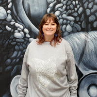 Fragile Oceans heathered grey sweatshirt with manta ray screen print worn by our AMCS team.