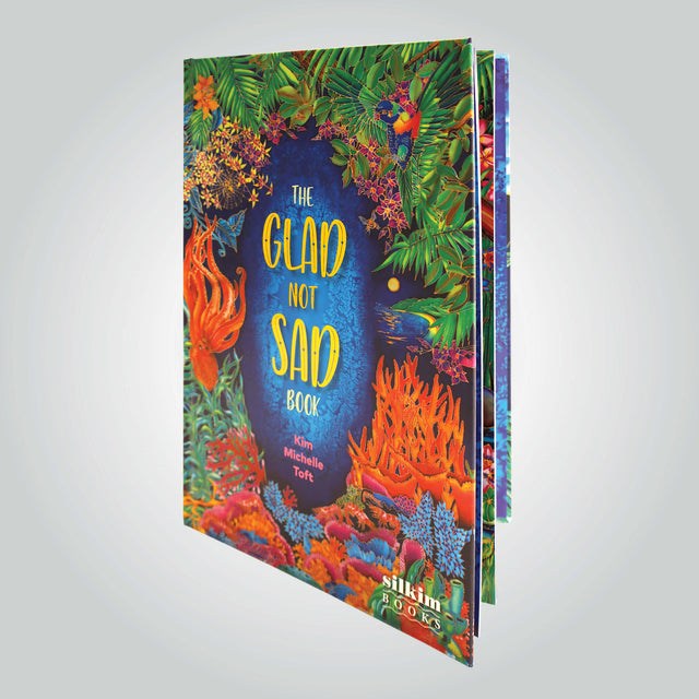 'The Glad Not Sad Book' cover by Kim Michelle Toft, featuring a vibrant illustration of the colourful coral, flora and wildlife.