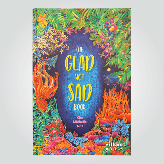 'The Glad Not Sad Book' cover by Kim Michelle Toft, featuring a vibrant illustration of the colourful coral, flora and wildlife.