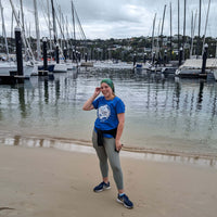 AMCS team member wearing Headsox buff with a boat marina and yachts in the background.
