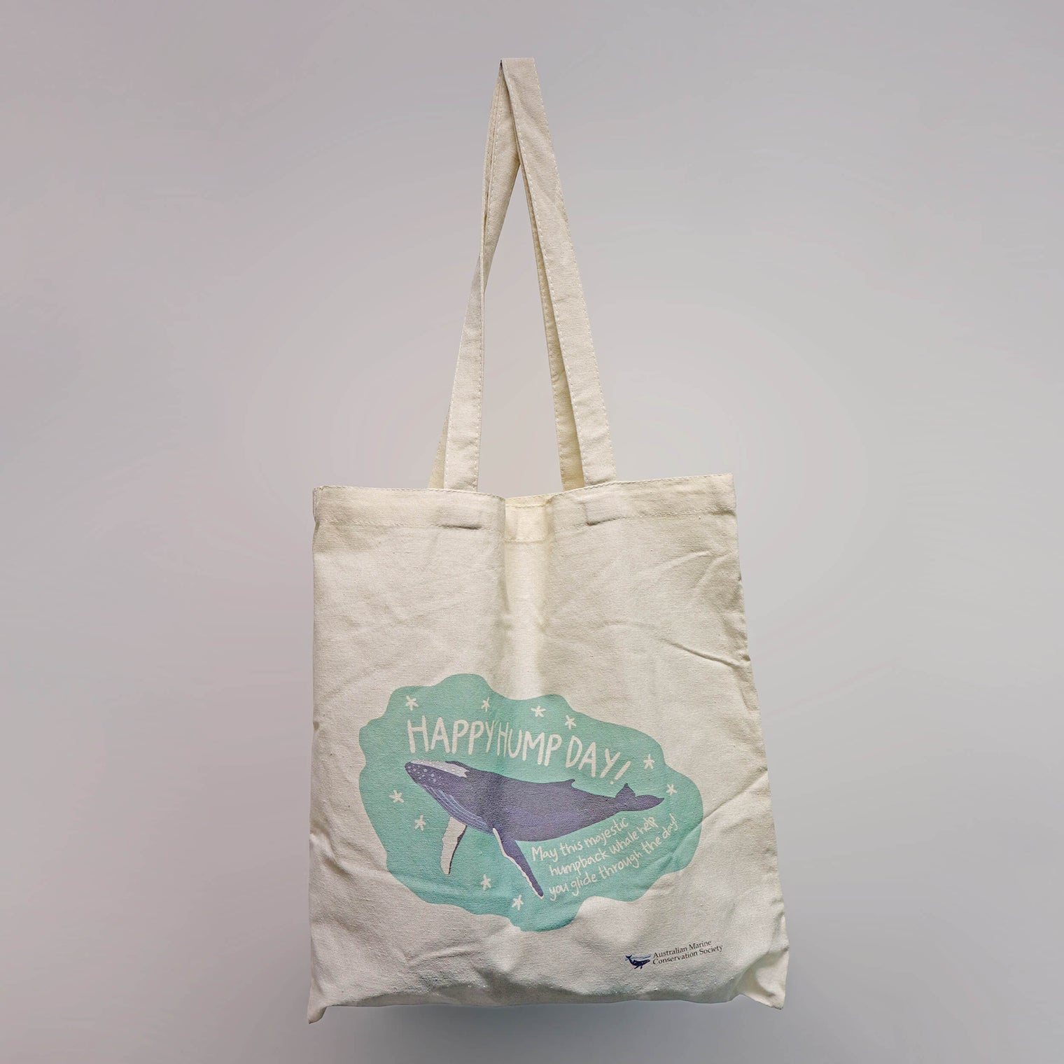 'Happy Hump Day!' recycled natural-coloured cotton tote bag a navy and green illustration print of a humpback whale by Red Parka.