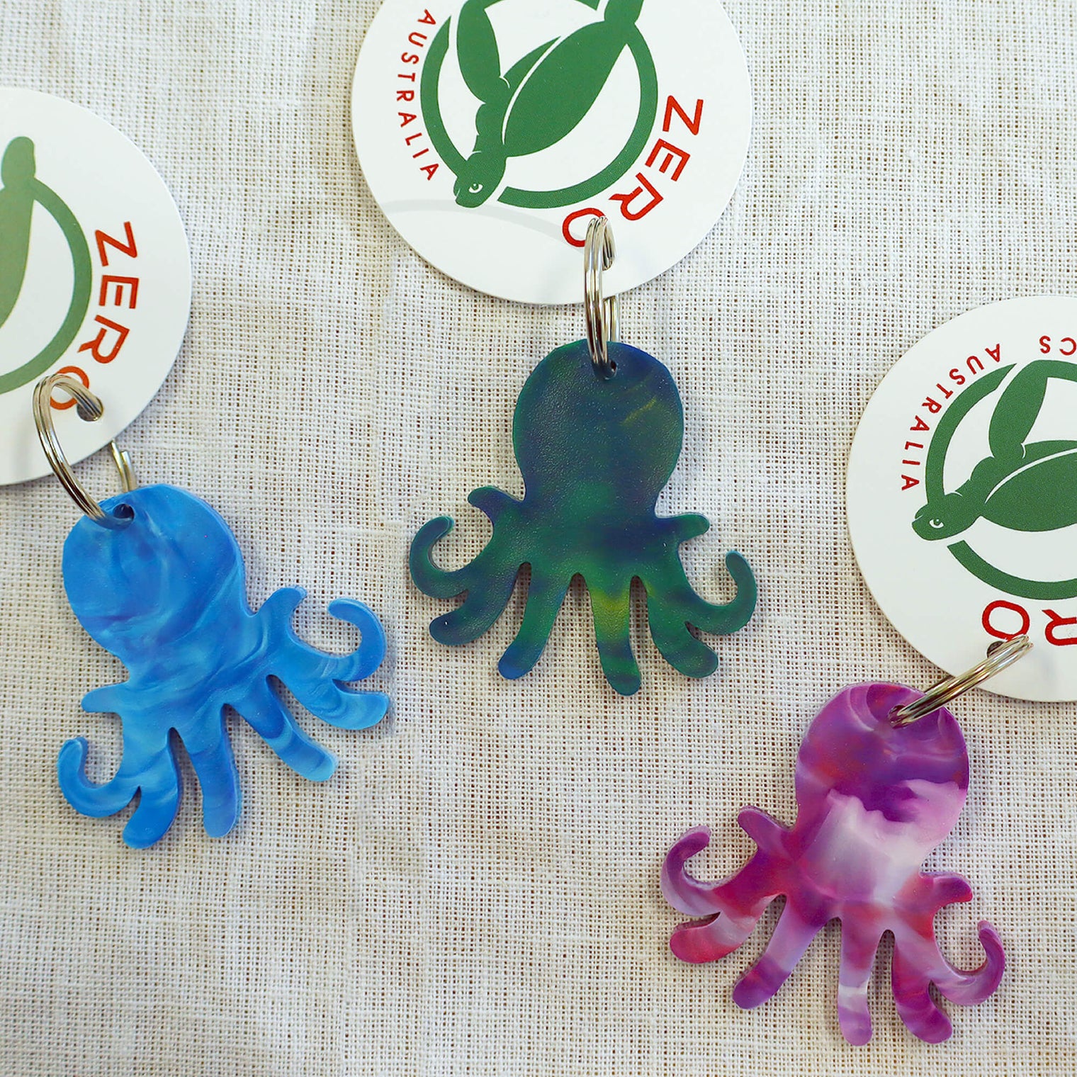 Purple, blue and green octopus shaped keyrings made with recycled plastic milk bottle lids.