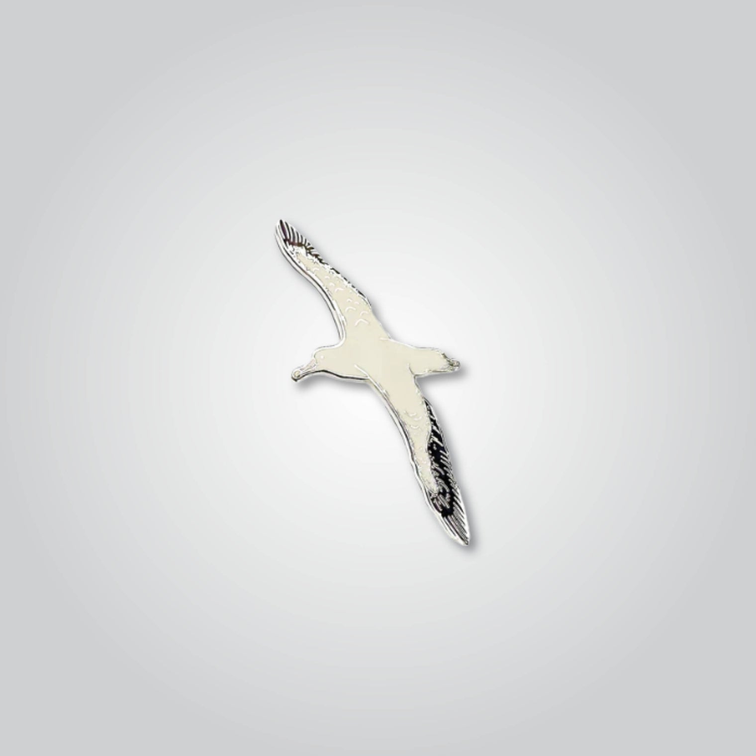 Lapel pin of an albatross by Red Parka. 