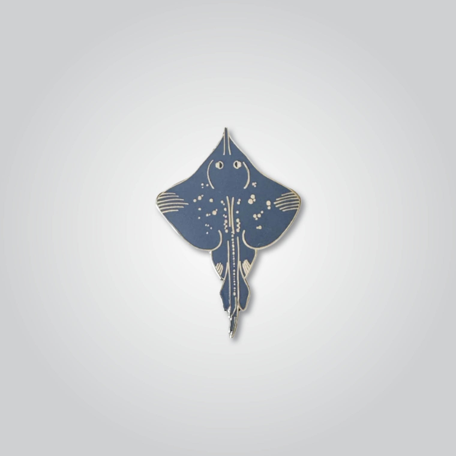 Lapel pin of a Maugean skate by Red Parka. 