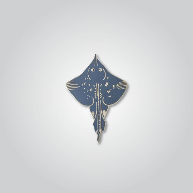 Lapel pin of a Maugean skate by Red Parka. 