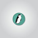 Lapel pin of a little penguin by Red Parka. 
