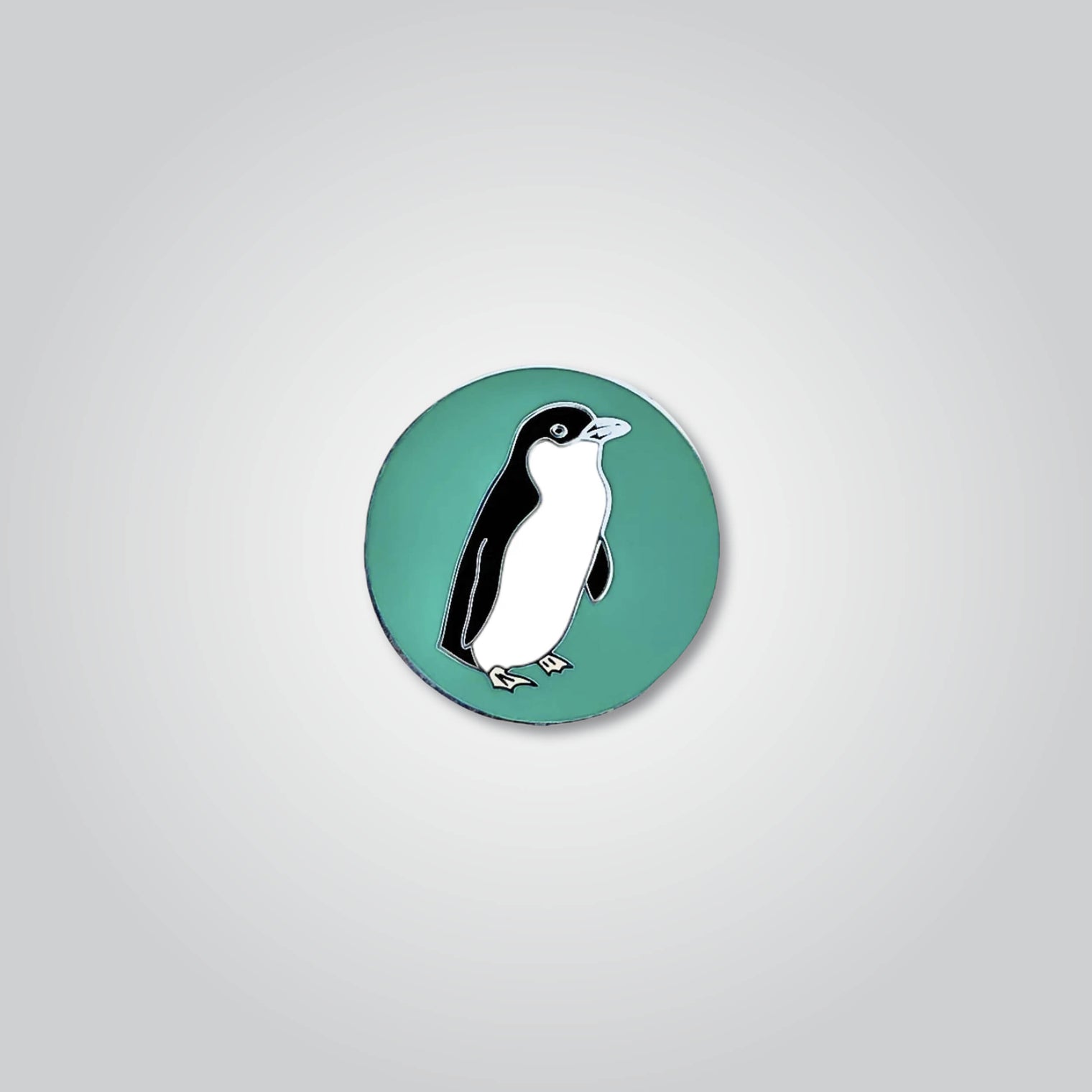 Lapel pin of a little penguin by Red Parka. 