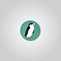 Lapel pin of a little penguin by Red Parka. 