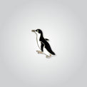 Lapel pin of a little penguin by Red Parka. 
