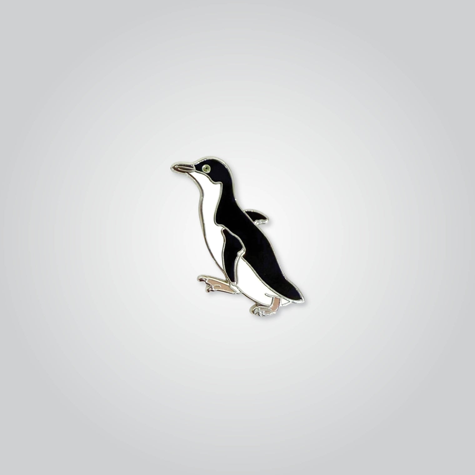 Lapel pin of a little penguin by Red Parka. 