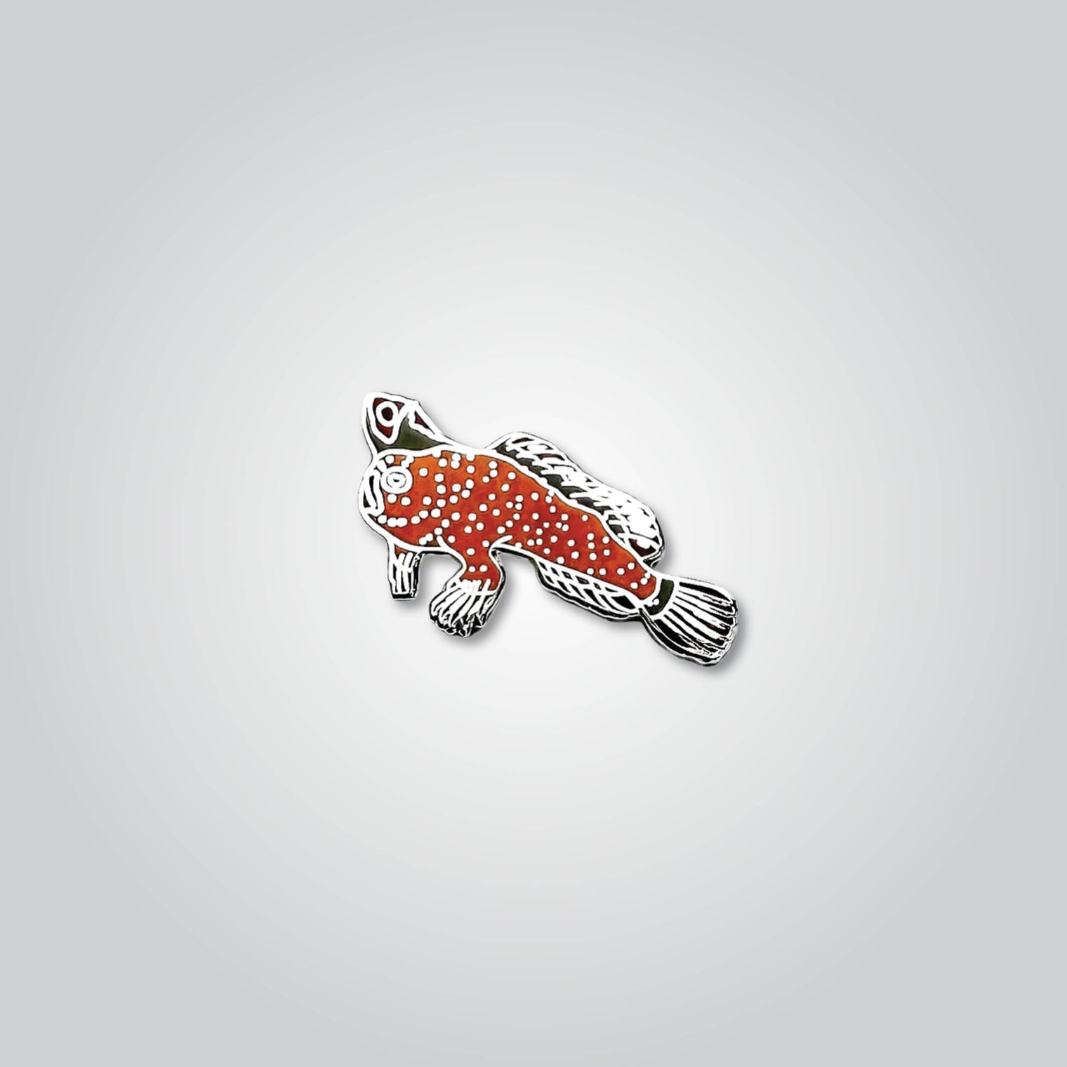 Lapel pin of a red handfish by Red Parka. 