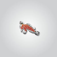 Lapel pin of a red handfish by Red Parka. 