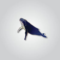 Lapel pin of a humpback whale by Red Parka. 