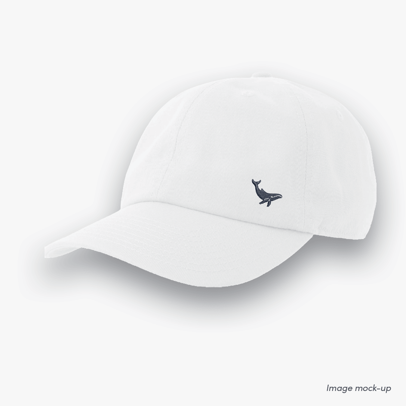 White-coloured Ocean Icons Dad cap with humpback whale embroidery on the side.