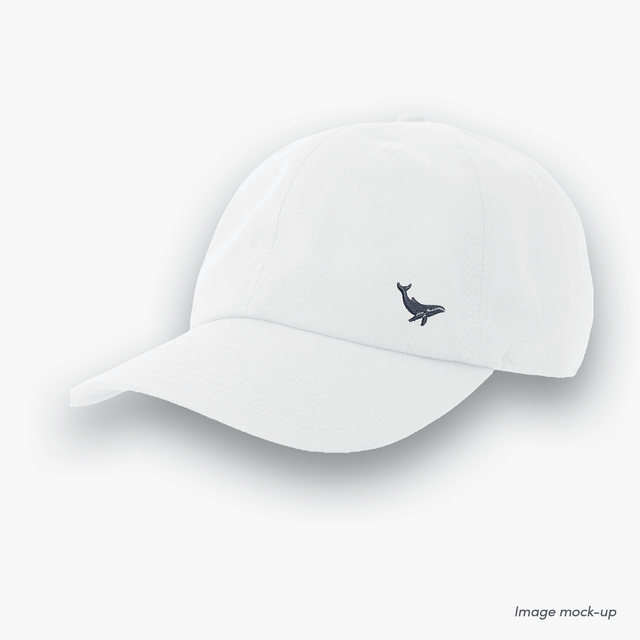 White-coloured Ocean Icons Dad cap with humpback whale embroidery on the side.