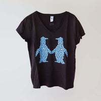 Ocean Love v-neck brown t-shirt (front) with a blue print of a pair of penguins, made from recycled materials. 