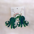 Green octopus-shaped dangle earrings, made with recycled plastic milk bottle lids by Zero Plastics Australia.