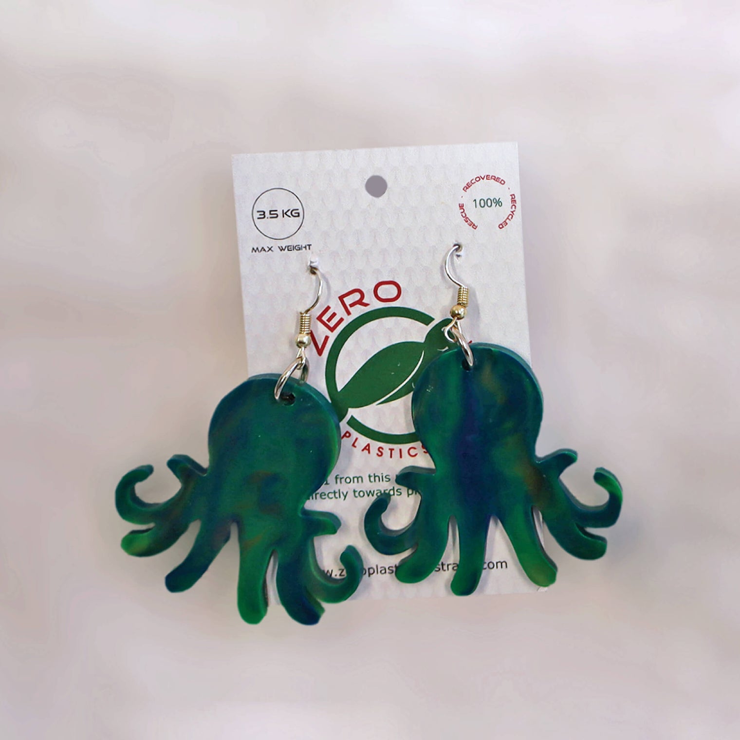Green octopus-shaped dangle earrings, made with recycled plastic milk bottle lids by Zero Plastics Australia.