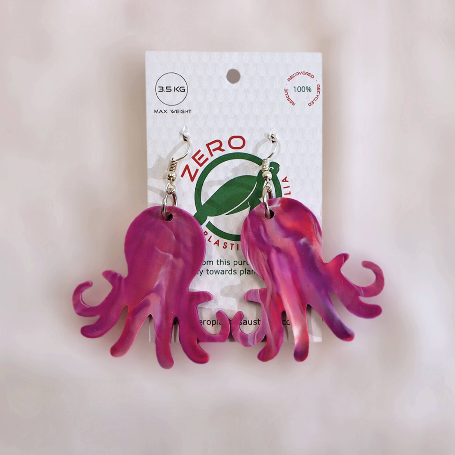 Pink octopus-shaped dangle earrings, made with recycled plastic milk bottle lids by Zero Plastics Australia.