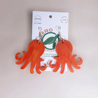 Orange-red octopus-shaped dangle earrings, made with recycled plastic milk bottle lids by Zero Plastics Australia.