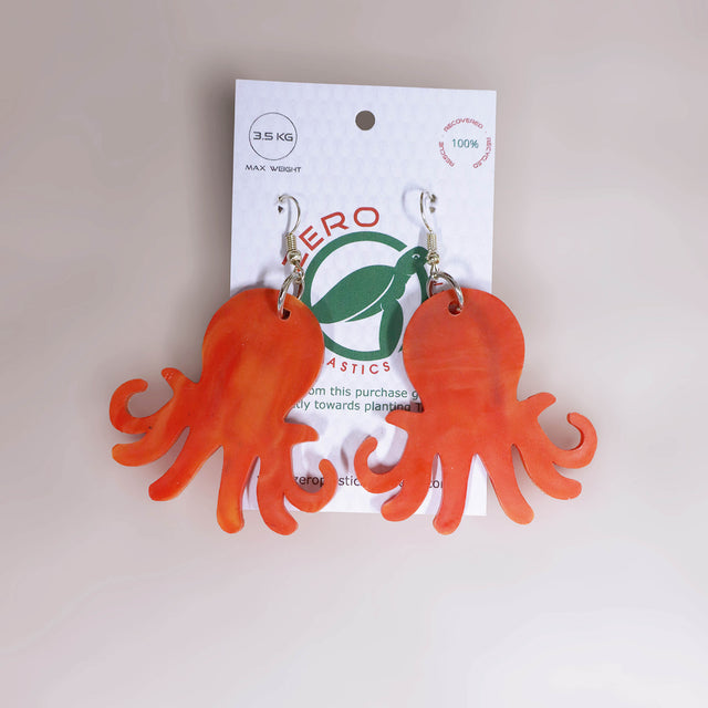 Orange-red octopus-shaped dangle earrings, made with recycled plastic milk bottle lids by Zero Plastics Australia.